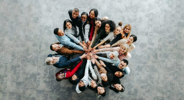top,view,of,a,diverse,team,of,people,joining,hands