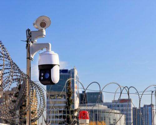 security,perimeter.,barbed,wire,fencing,,a,red,light,and,cameras