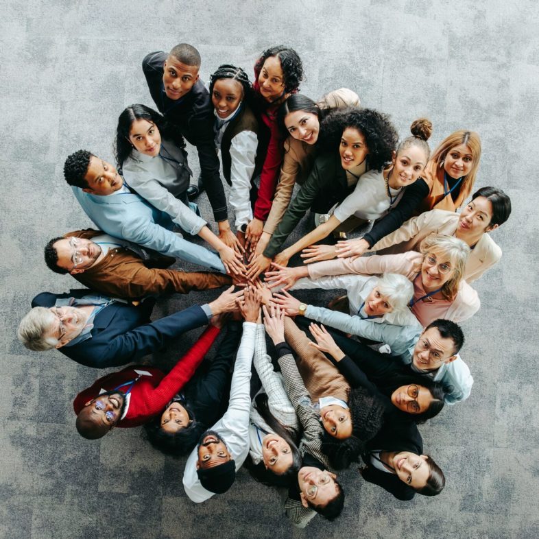top,view,of,a,diverse,team,of,people,joining,hands